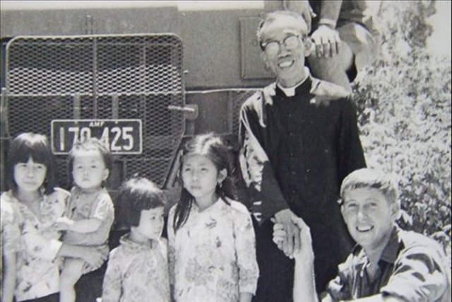 Ray at the Orphanage with the Priest and kids