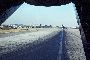 On a runway at Tan Son Nhut looking out the e back of a Caribou "Callsign Wallaby" with a F4 Phantom and a DC3 behind it on the runway.